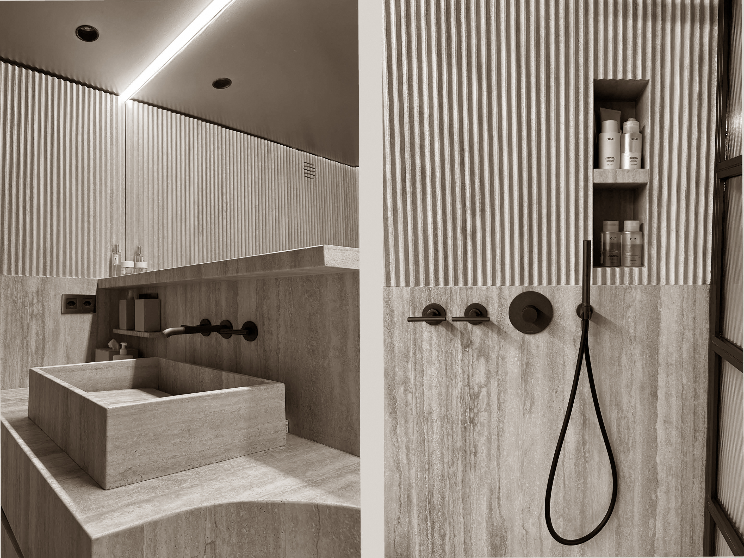 Striking bathroom interior combining fluted wall textures with smooth stone surfaces for a rich tactile contrast. A bold stone sink, matte black fixtures, and recessed shelving reflect a careful balance between minimalist design and warm materiality, offering both elegance and functionality. Striking bathroom interior combining fluted wall textures with smooth stone surfaces for a rich tactile contrast. A bold stone sink, matte black fixtures, and recessed shelving reflect a careful balance between minimalist design and warm materiality, offering both elegance and functionality.