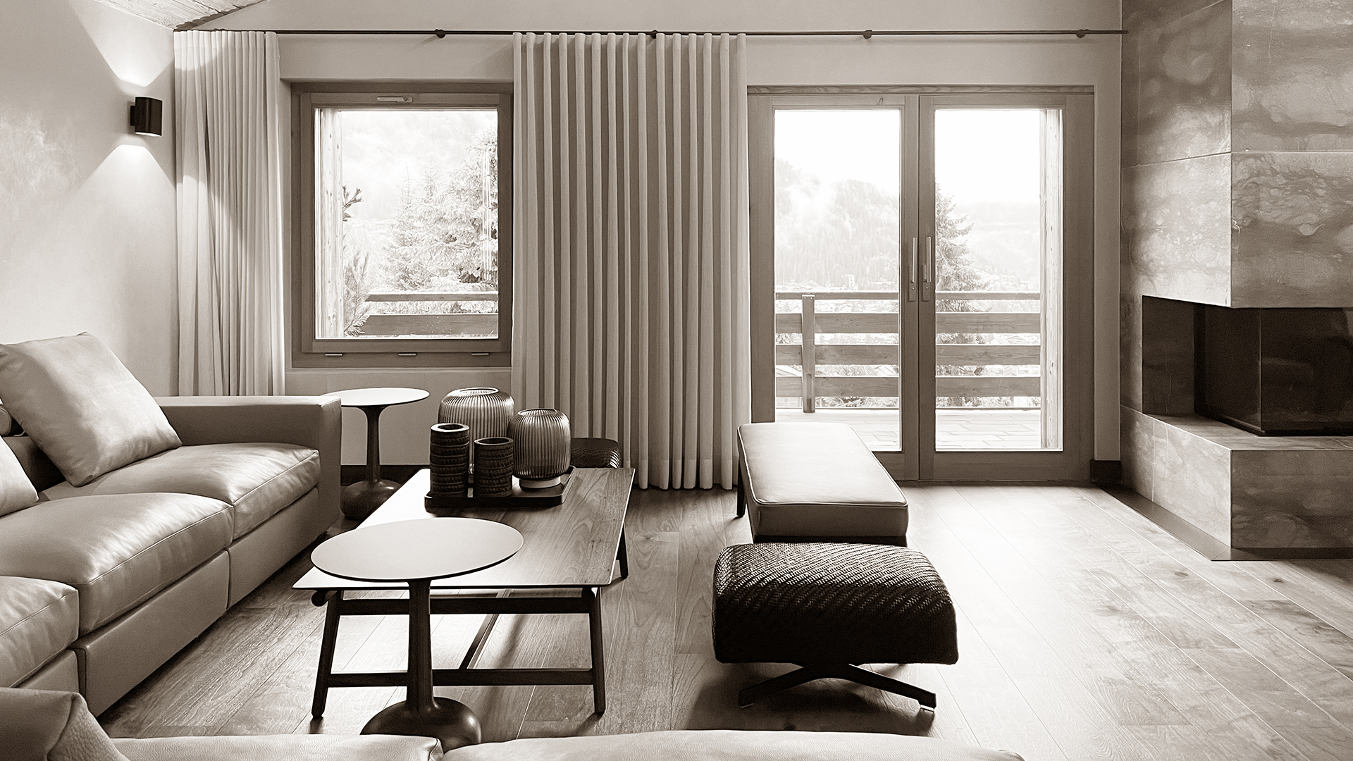 Cozy sofa corner in the living room of Chalet Harmony, featuring luxurious leather seating, soft cushions, and modern lighting, creating a comfortable and inviting space for relaxation.