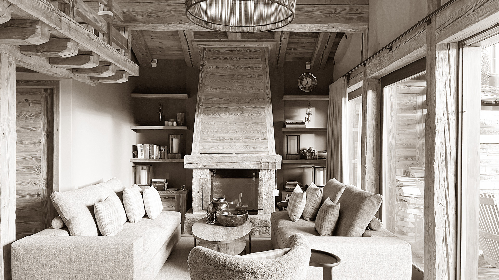 Cozy living room area centered around a modern fireplace, featuring two comfortable sofas and a single armchair, creating a warm and inviting space for relaxation and conversation.